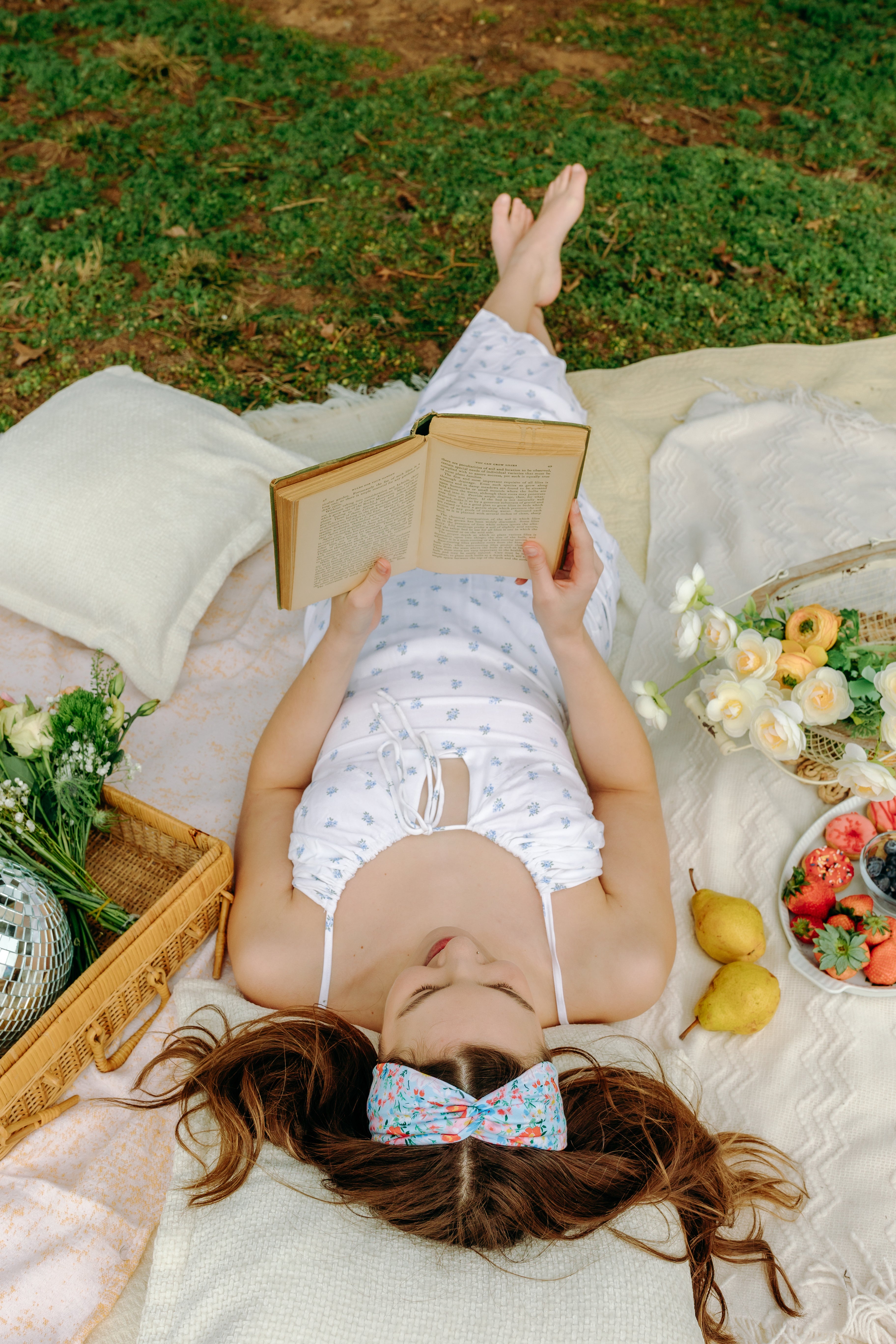 Woman smiling and confidently wearing the Zoey Floral on Sky Blue headband, the perfect non-slip accessory for long shifts or play days.