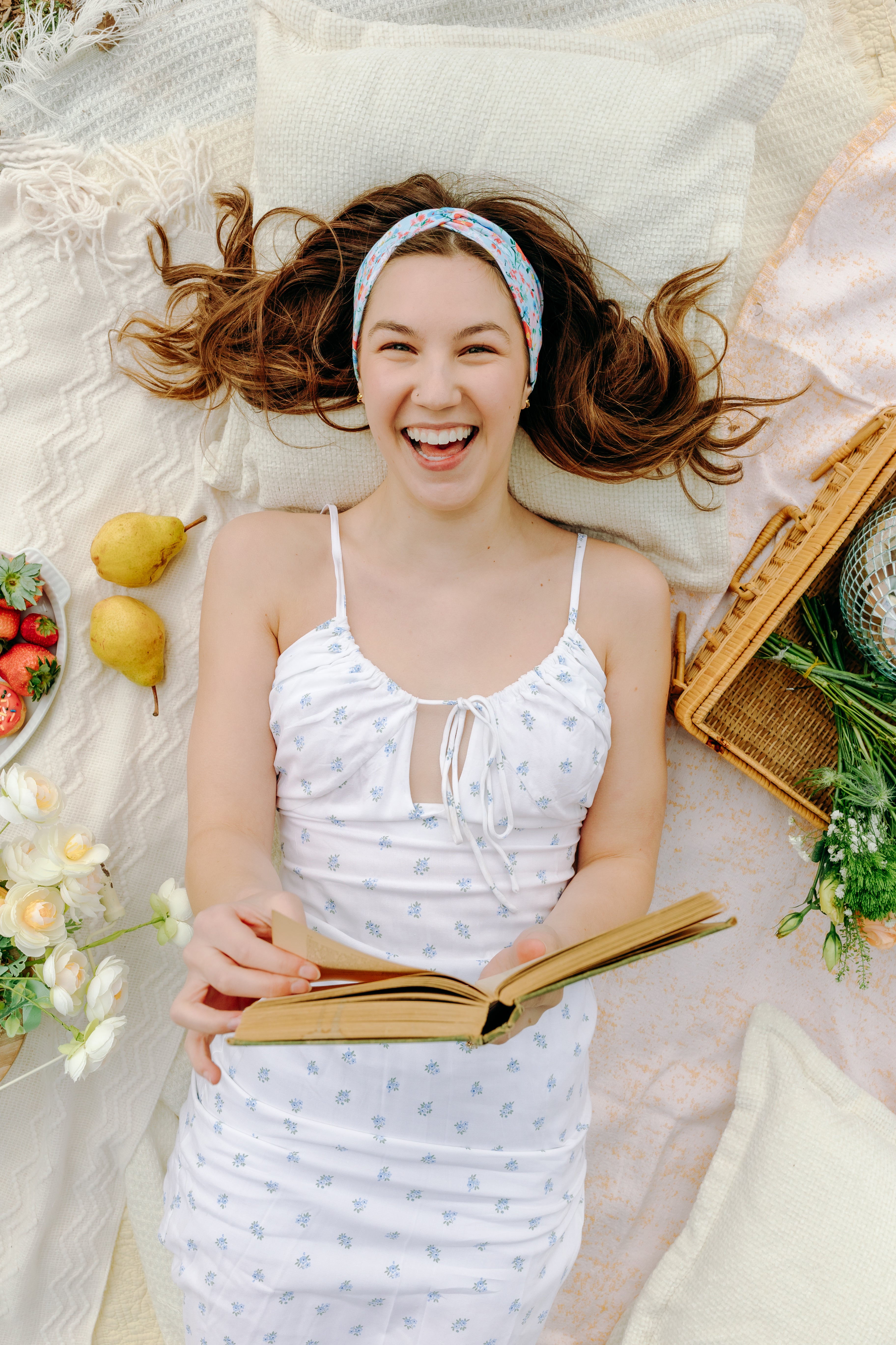 Woman smiling and confidently wearing the Zoey Floral on Sky Blue headband, the perfect non-slip accessory for long shifts or play days.