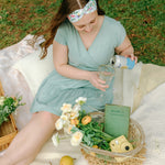 Woman smiling while wearing the Isabella Floral on Ivory headband, the perfect non-slip accessory for work or workouts.