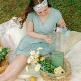 Woman smiling while wearing the Isabella Floral on Ivory headband, the perfect non-slip accessory for work or workouts.