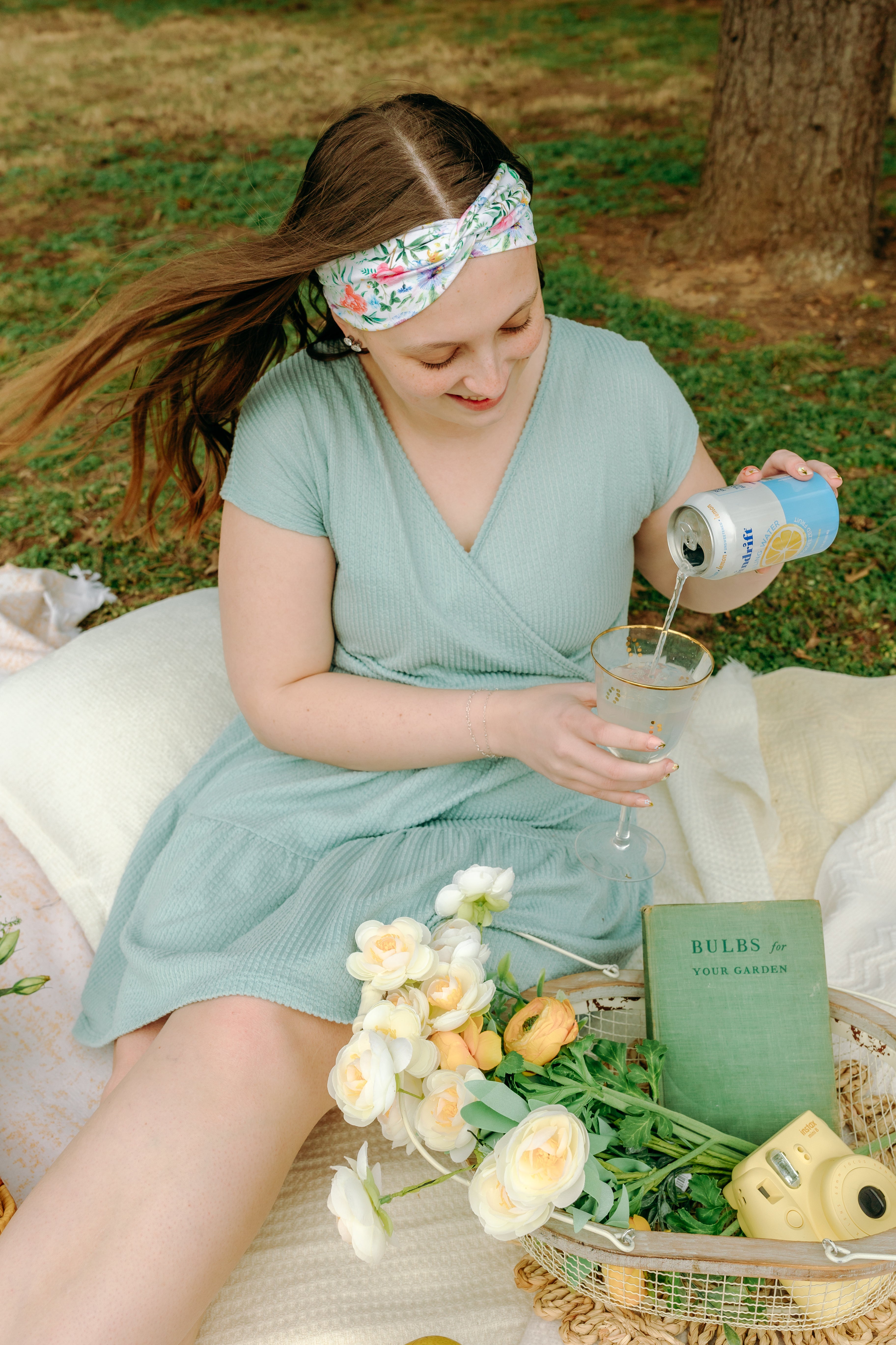 Woman smiling while wearing the Isabella Floral on Ivory headband, the perfect non-slip accessory for work or workouts.