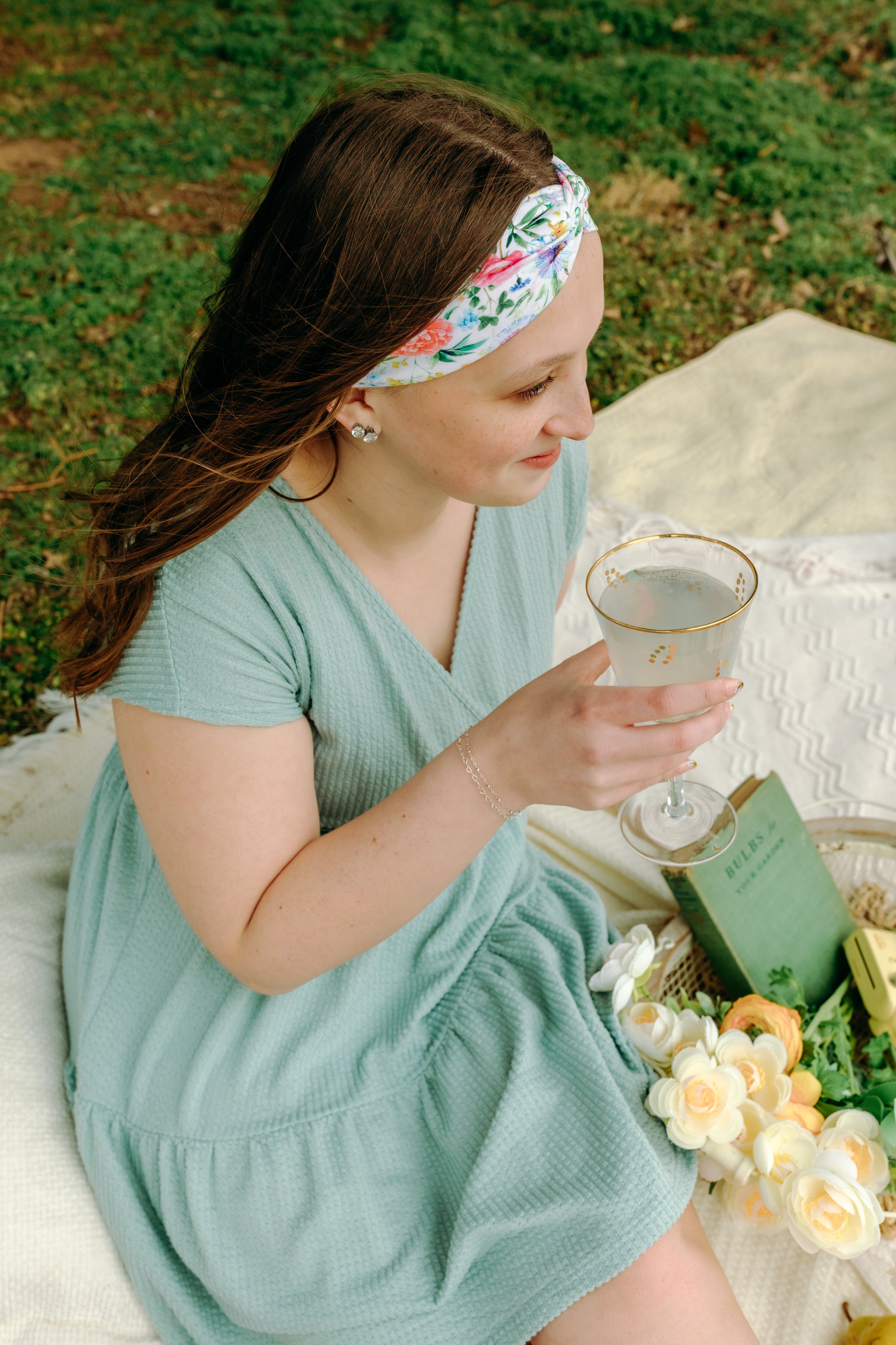 Woman smiling while wearing the Isabella Floral on Ivory headband, the perfect non-slip accessory for work or workouts.