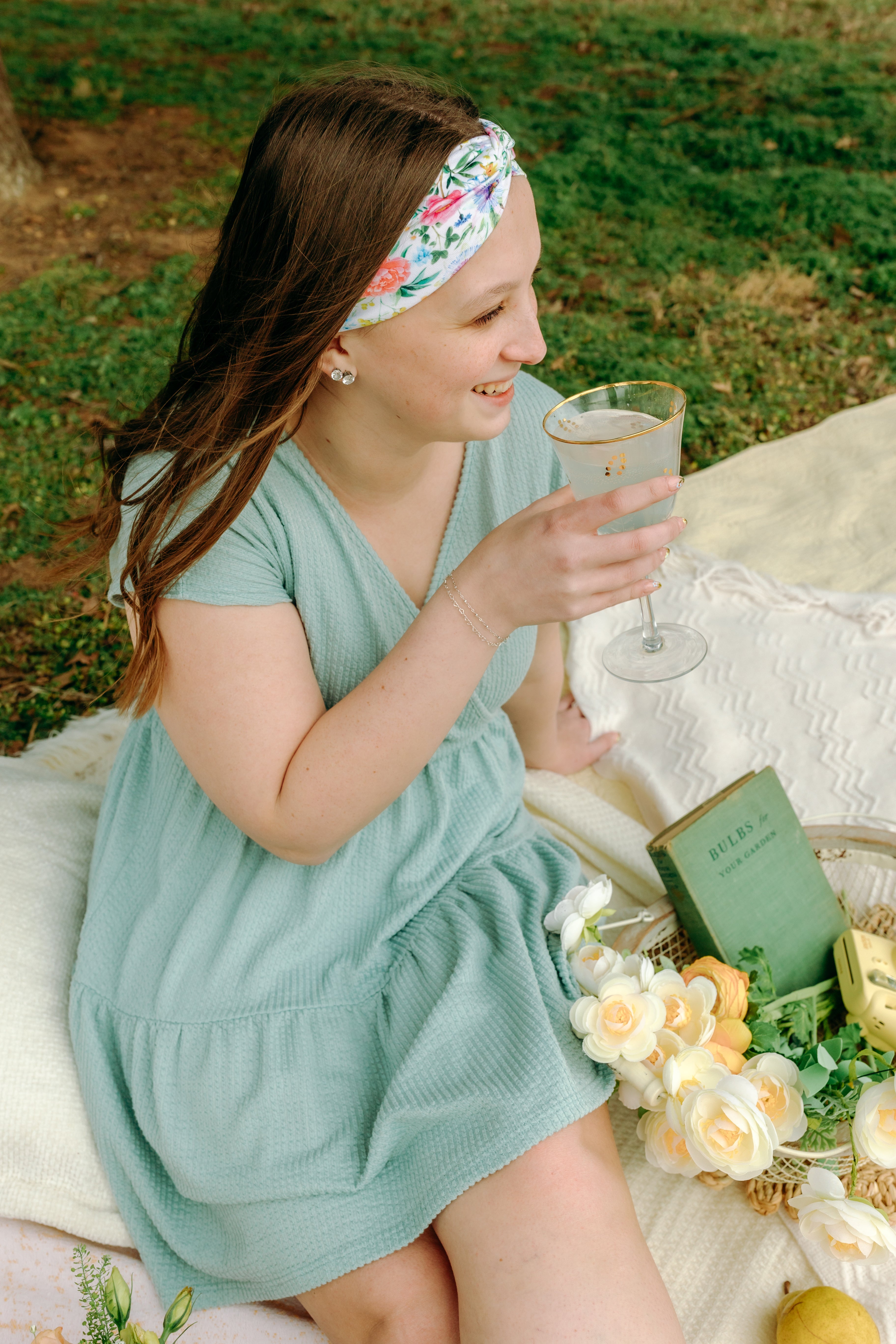 Woman smiling while wearing the Isabella Floral on Ivory headband, the perfect non-slip accessory for work or workouts.