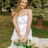 Woman smiling while wearing the Sydney Floral on Beige headband, the perfect non-slip accessory for work or workouts.