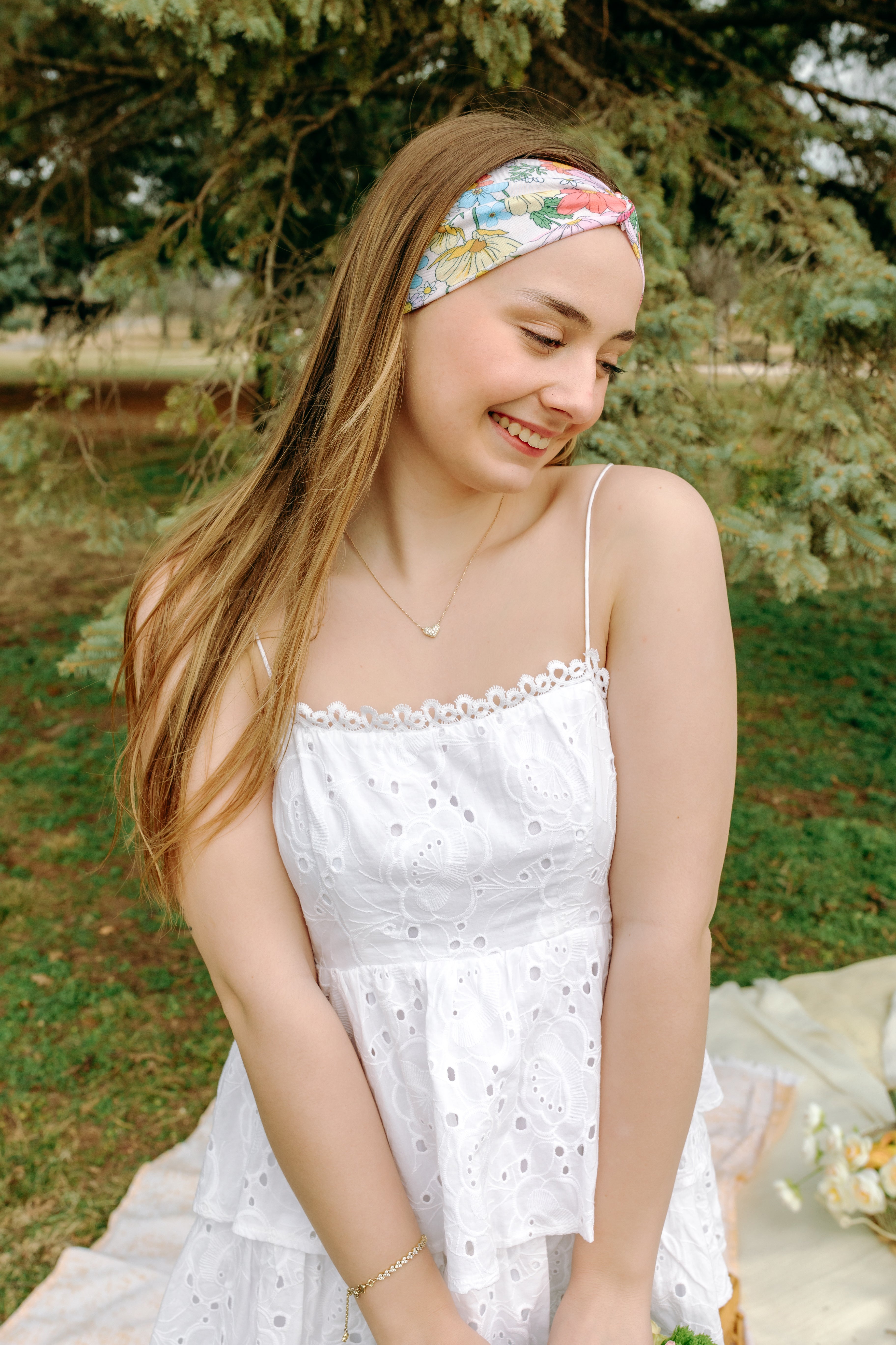 Woman smiling while wearing the Sydney Floral on Beige headband, the perfect non-slip accessory for work or workouts.