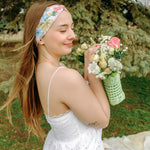 Woman smiling while wearing the Sydney Floral on Beige headband, the perfect non-slip accessory for work or workouts.