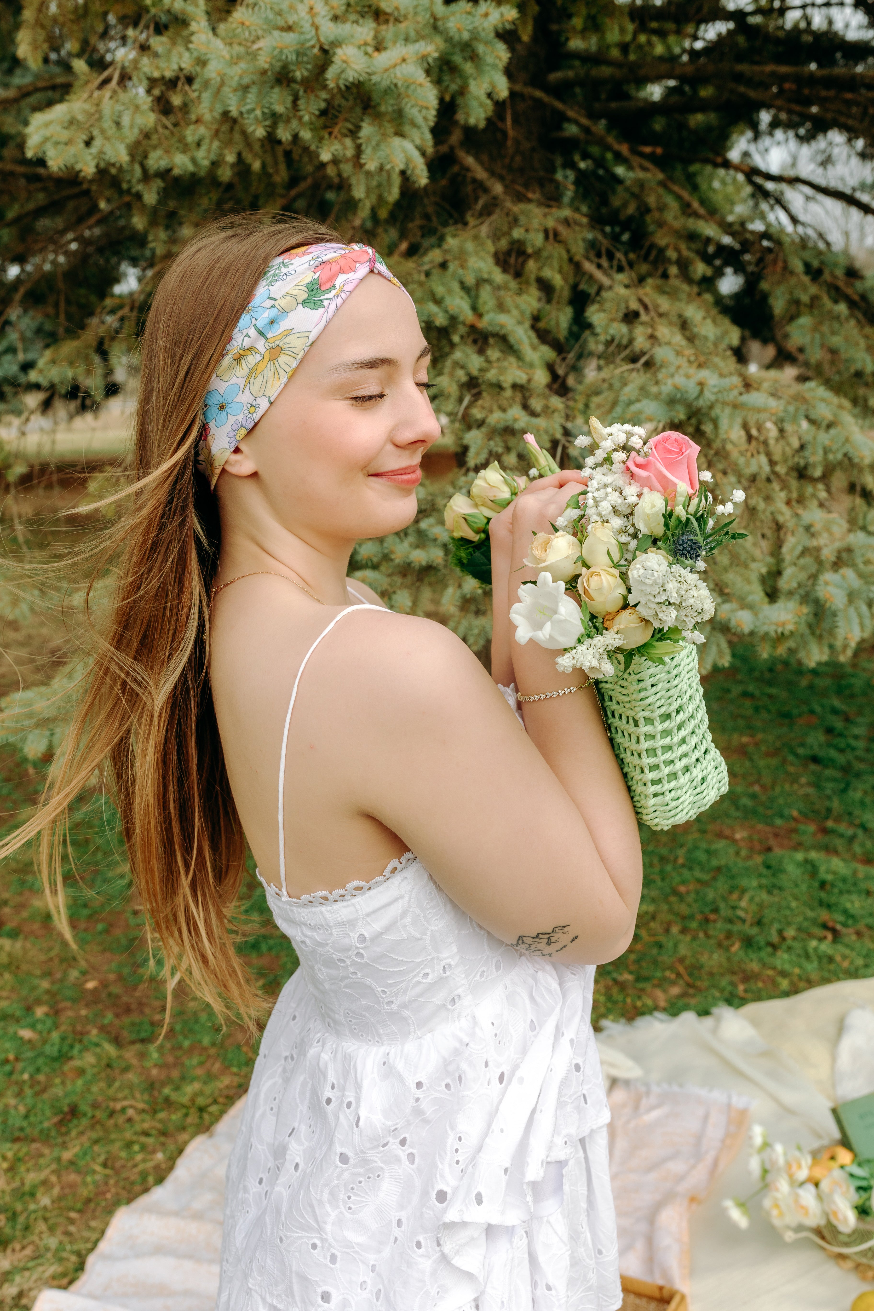 Woman smiling while wearing the Sydney Floral on Beige headband, the perfect non-slip accessory for work or workouts.