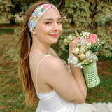 Woman smiling while wearing the Sydney Floral on Beige headband, the perfect non-slip accessory for work or workouts.