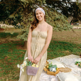 Woman with long hair confidently wearing the Willow Floral on Ivory headband, the perfect non-slip accessory for long shifts or play days.