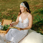 Woman with long hair confidently wearing the Tori Floral on Sage headband, the perfect non-slip accessory for long shifts or play days.