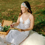 Woman with long hair confidently wearing the Tori Floral on Sage headband, the perfect non-slip accessory for long shifts or play days.