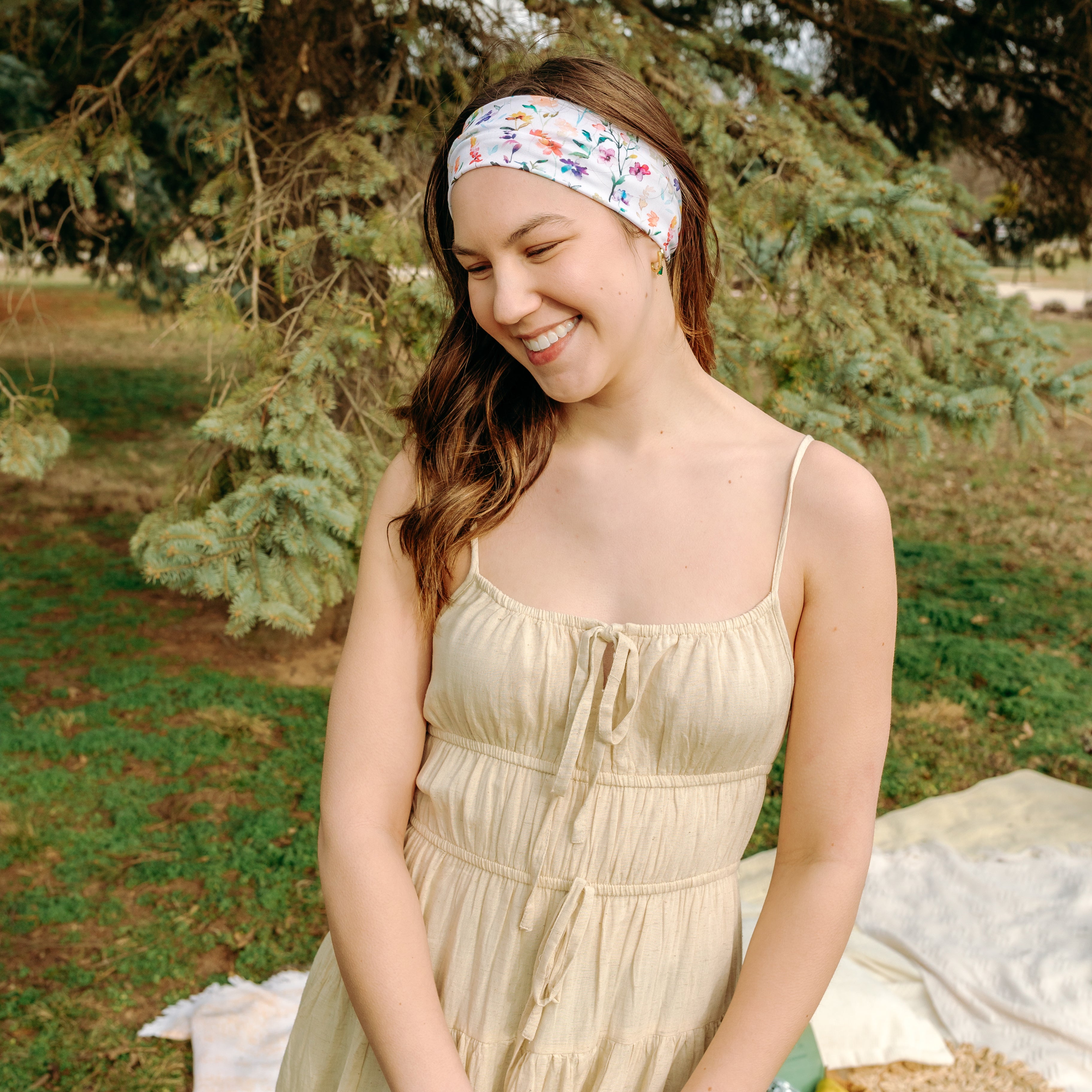 Woman with long hair confidently wearing the Willow Floral on Ivory headband, the perfect non-slip accessory for long shifts or play days.