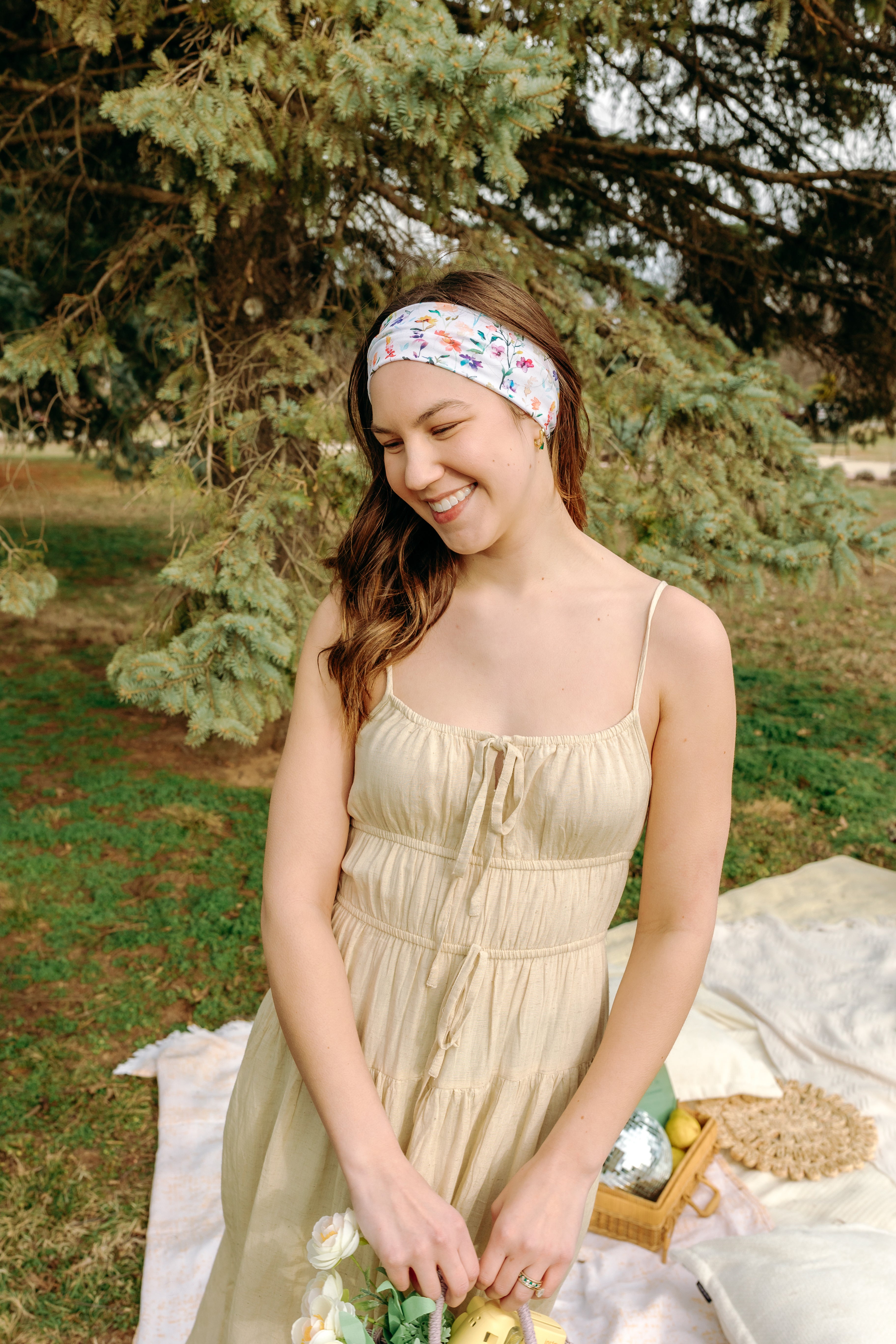 Woman with long hair confidently wearing the Willow Floral on Ivory headband, the perfect non-slip accessory for long shifts or play days.