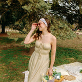 Woman with long hair confidently wearing the Willow Floral on Ivory headband, the perfect non-slip accessory for long shifts or play days.
