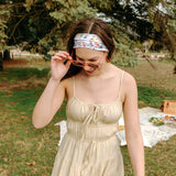 Woman with long hair confidently wearing the Willow Floral on Ivory headband, the perfect non-slip accessory for long shifts or play days.