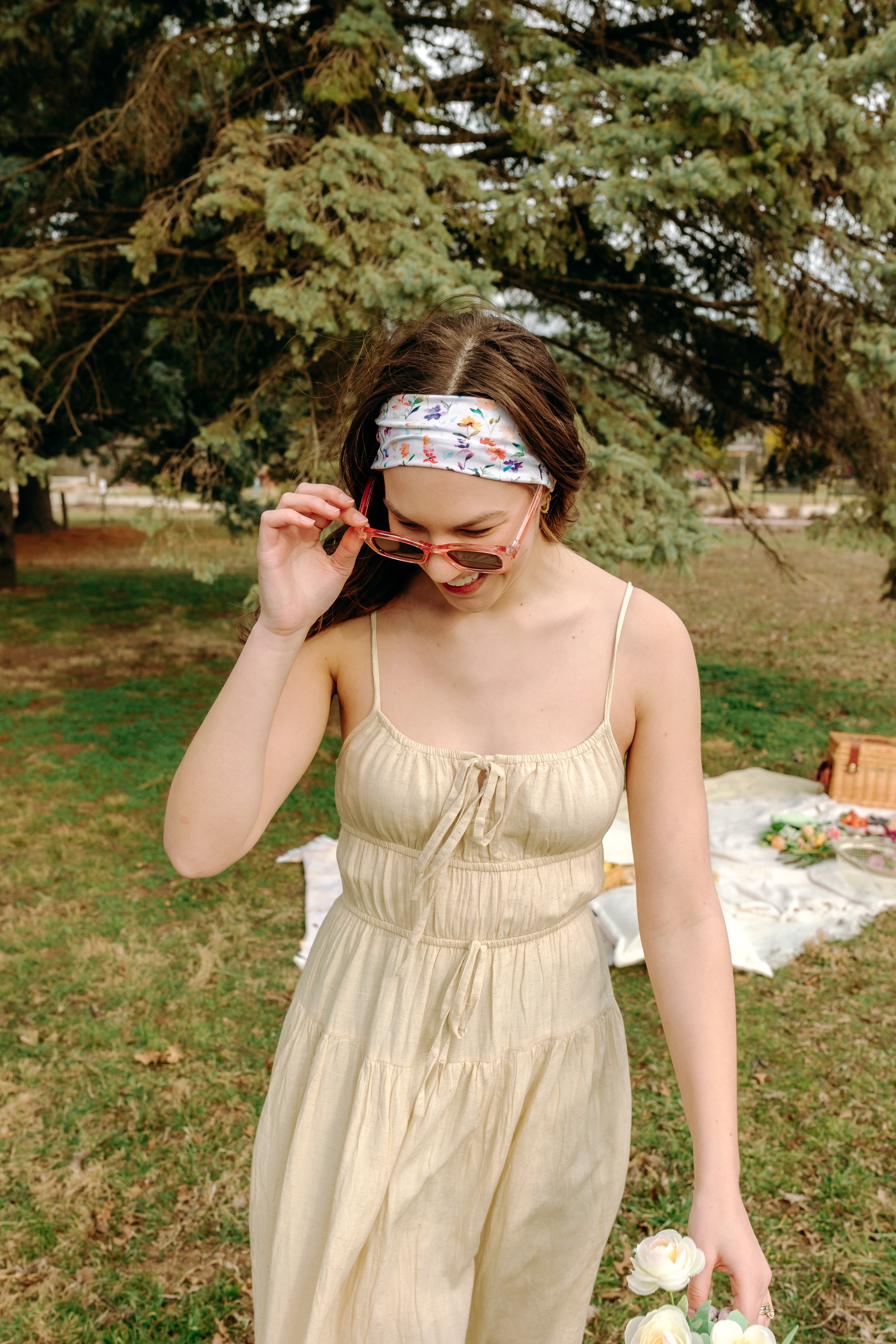 Woman with long hair confidently wearing the Willow Floral on Ivory headband, the perfect non-slip accessory for long shifts or play days.