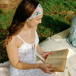 Woman with long hair confidently wearing the Tori Floral on Sage headband, the perfect non-slip accessory for long shifts or play days.