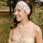 Woman with long hair confidently wearing the Willow Floral on Ivory headband, the perfect non-slip accessory for long shifts or play days.