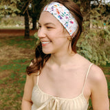 Woman with long hair confidently wearing the Willow Floral on Ivory headband, the perfect non-slip accessory for long shifts or play days.