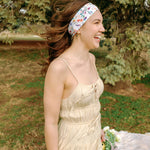 Woman with long hair confidently wearing the Willow Floral on Ivory headband, the perfect non-slip accessory for long shifts or play days.
