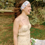Woman with long hair confidently wearing the Willow Floral on Ivory headband, the perfect non-slip accessory for long shifts or play days.