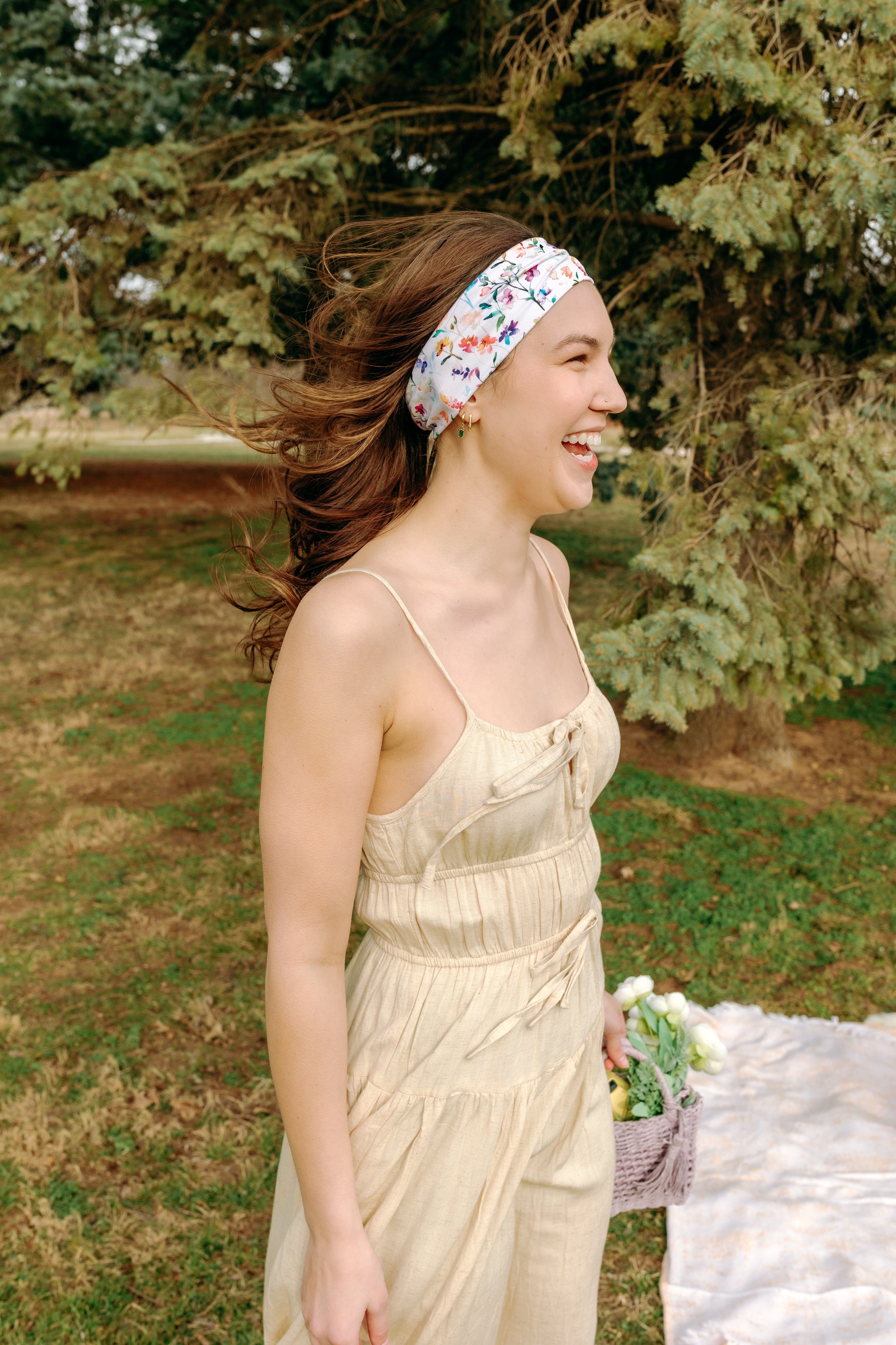 Woman with long hair confidently wearing the Willow Floral on Ivory headband, the perfect non-slip accessory for long shifts or play days.