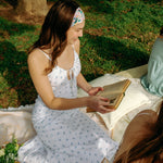 Woman with long hair confidently wearing the Tori Floral on Sage headband, the perfect non-slip accessory for long shifts or play days.