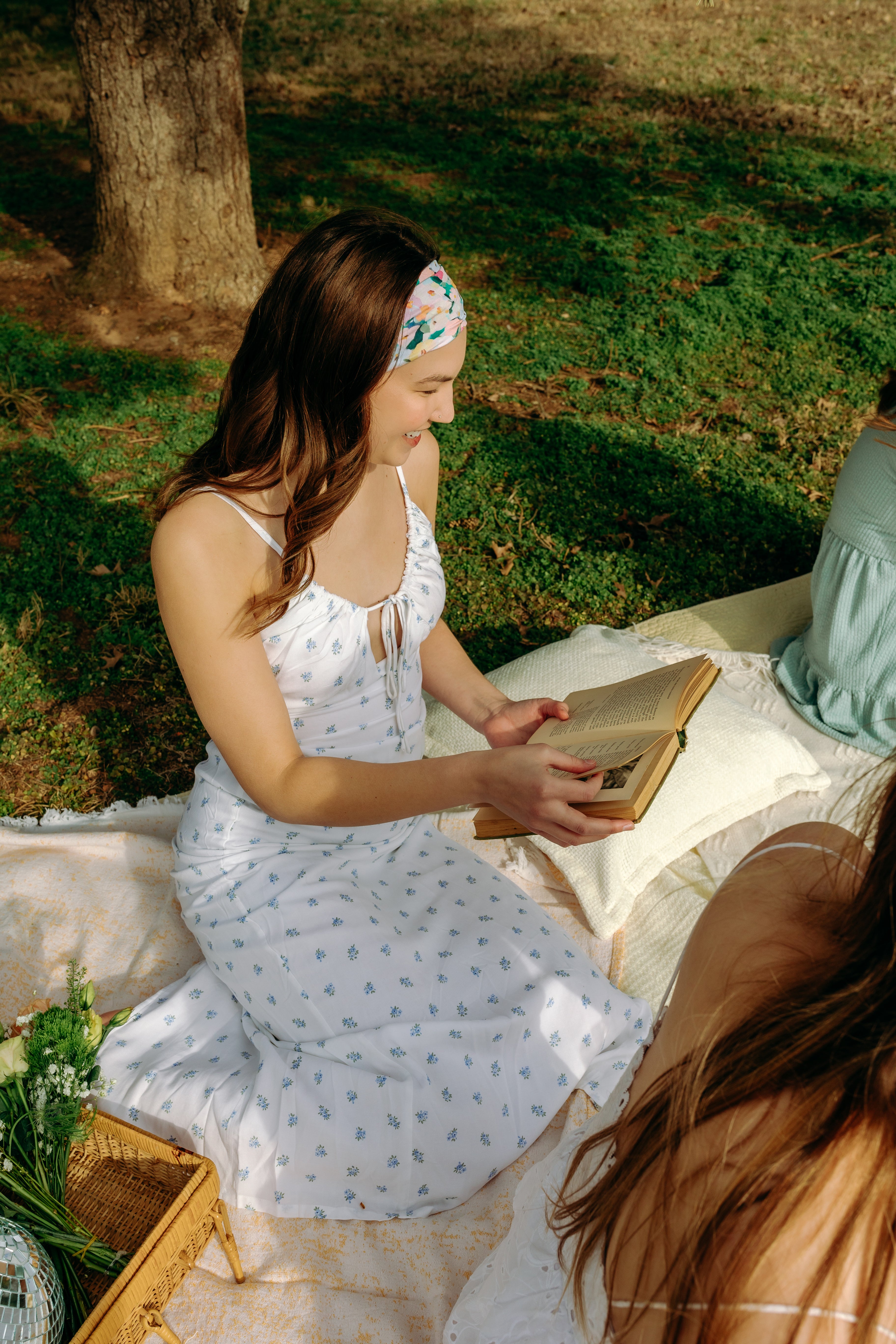 Woman with long hair confidently wearing the Tori Floral on Sage headband, the perfect non-slip accessory for long shifts or play days.