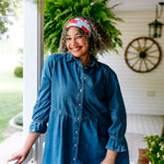 Woman with curly hair type happily wearing the most comfortable hand-made headband in the print You Look Like the Fourth of July.
