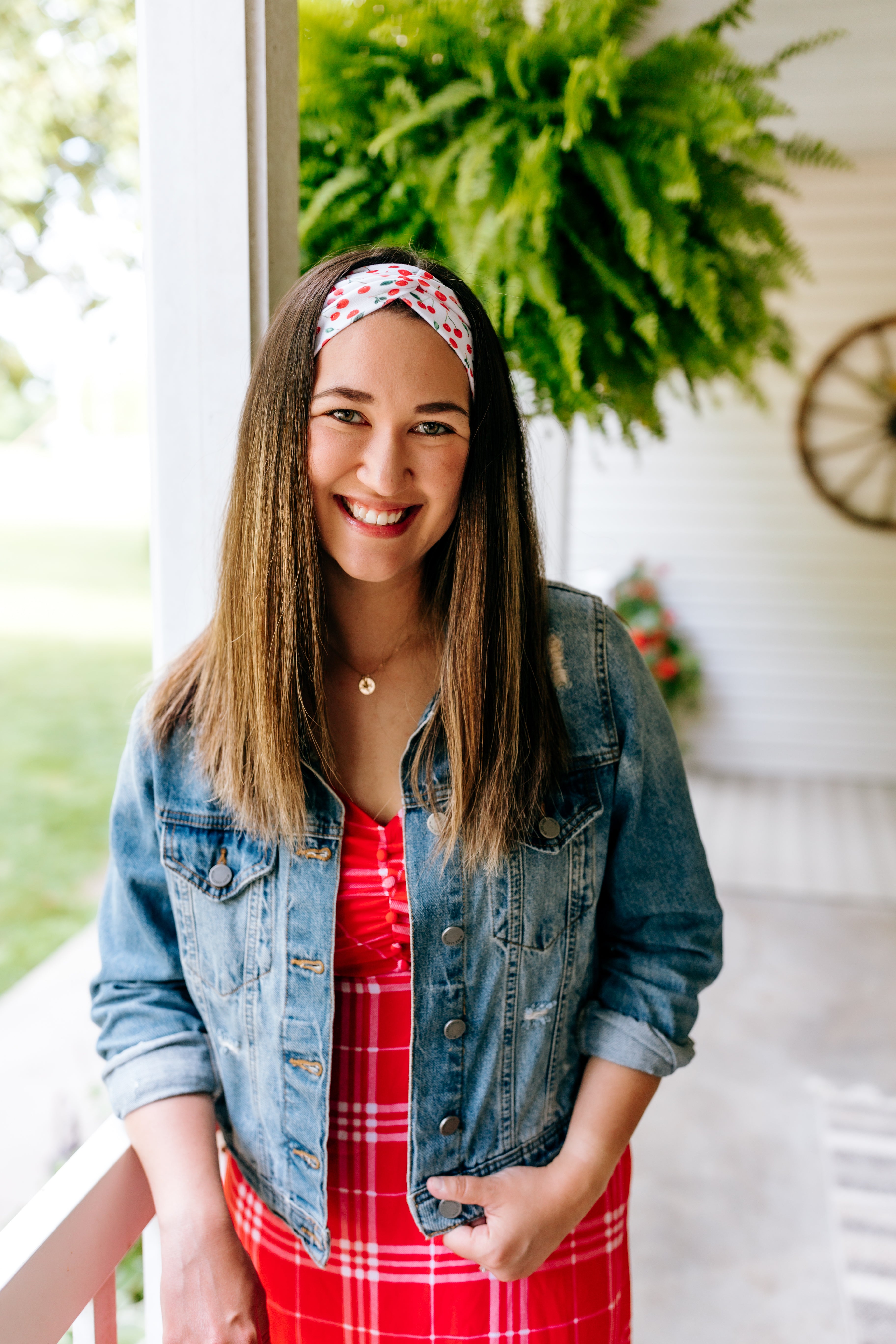 Woman with long straight hair type happily wearing the most comfortable hand-made headband in the print Life is Sweet.