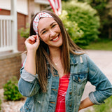 Woman with long straight hair type happily wearing the most comfortable hand-made headband in the print Life is Sweet.