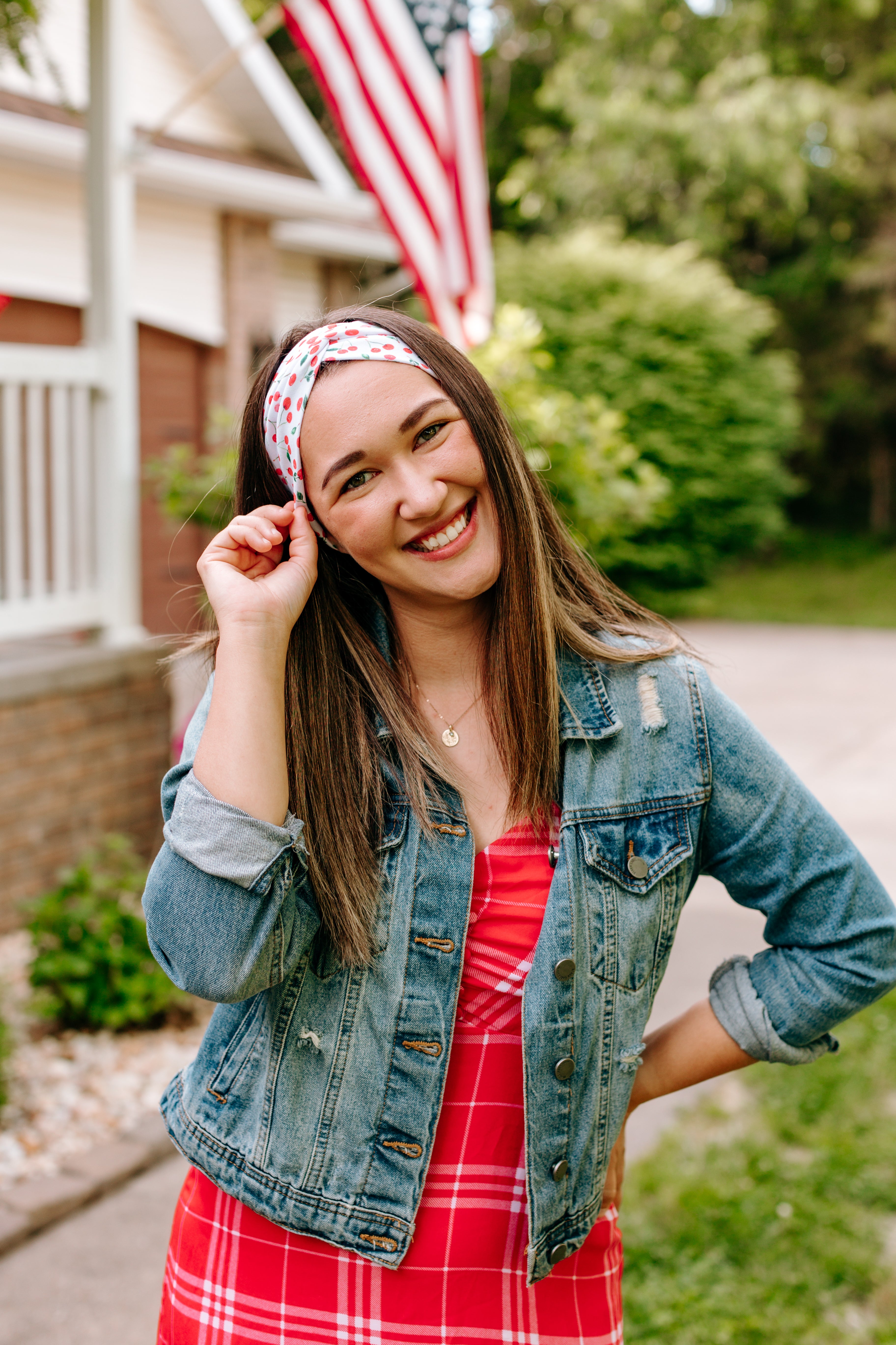 Woman with long straight hair type happily wearing the most comfortable hand-made headband in the print Life is Sweet.