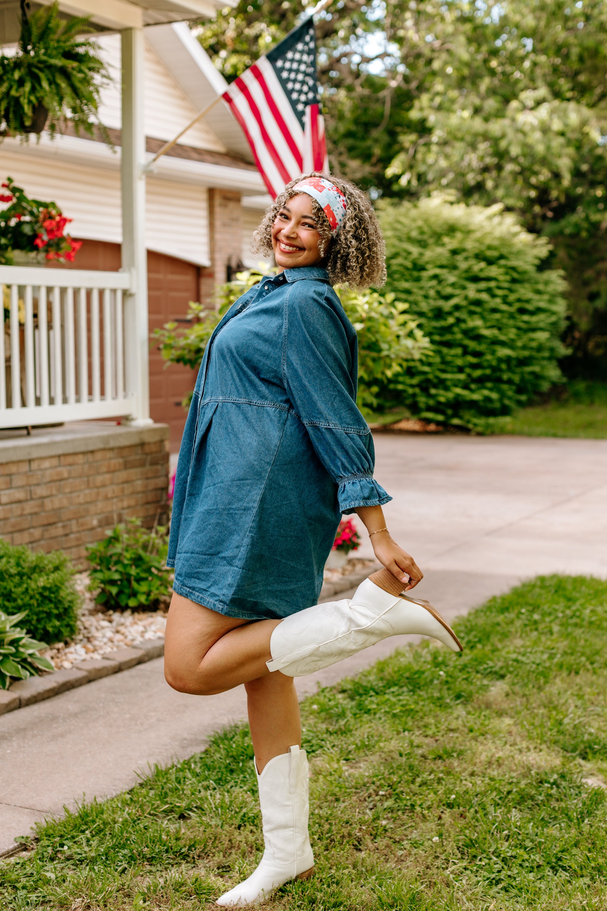 Woman with curly hair type happily wearing the most comfortable hand-made headband in the print You Look Like the Fourth of July.