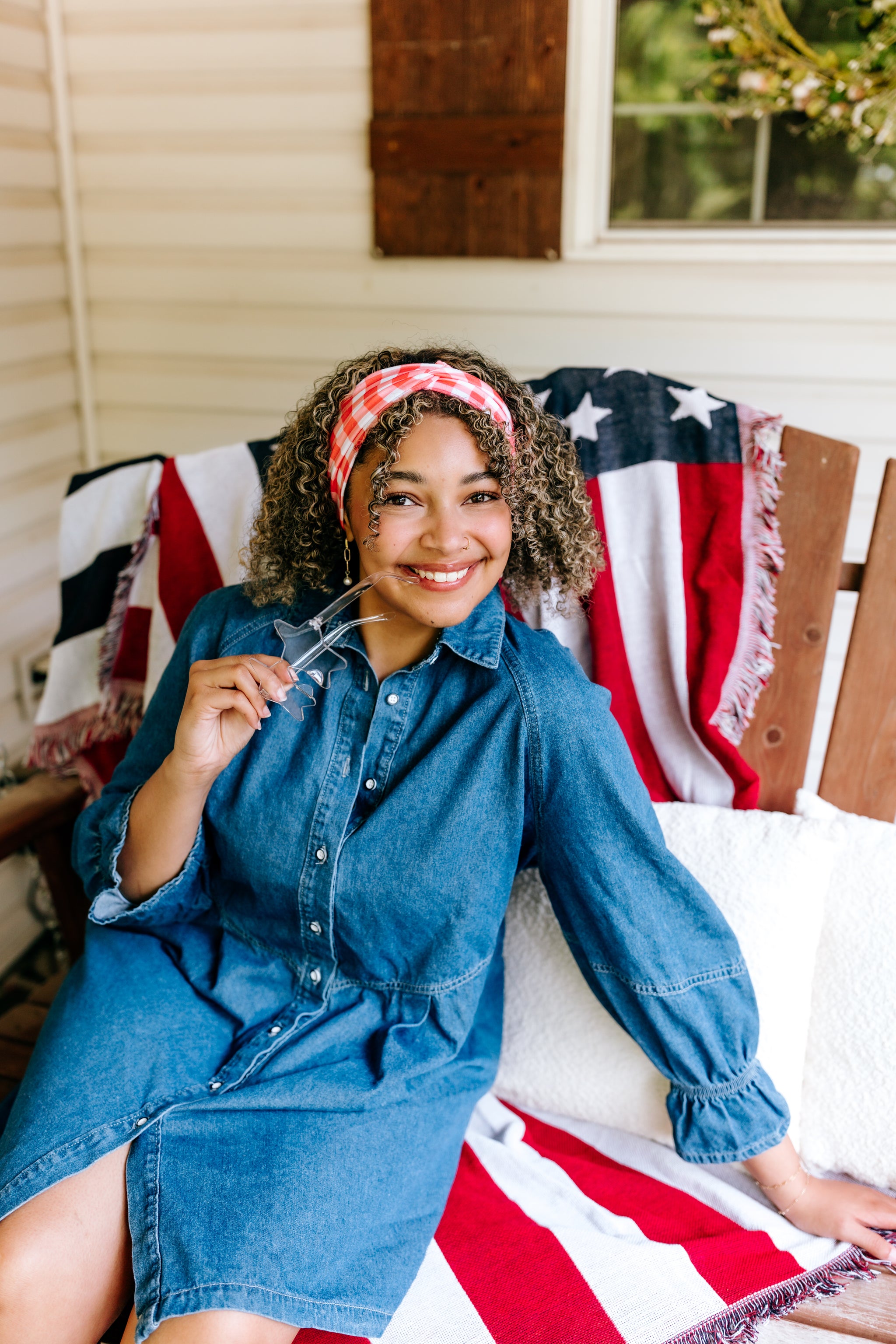 Woman with curly hair type happily wearing the most comfortable hand-made headband in the print More Picnics, Please!