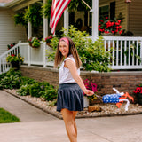 Woman with long straight hair type happily wearing the most comfortable hand-made headband in the print Summer Nights on Cherry.