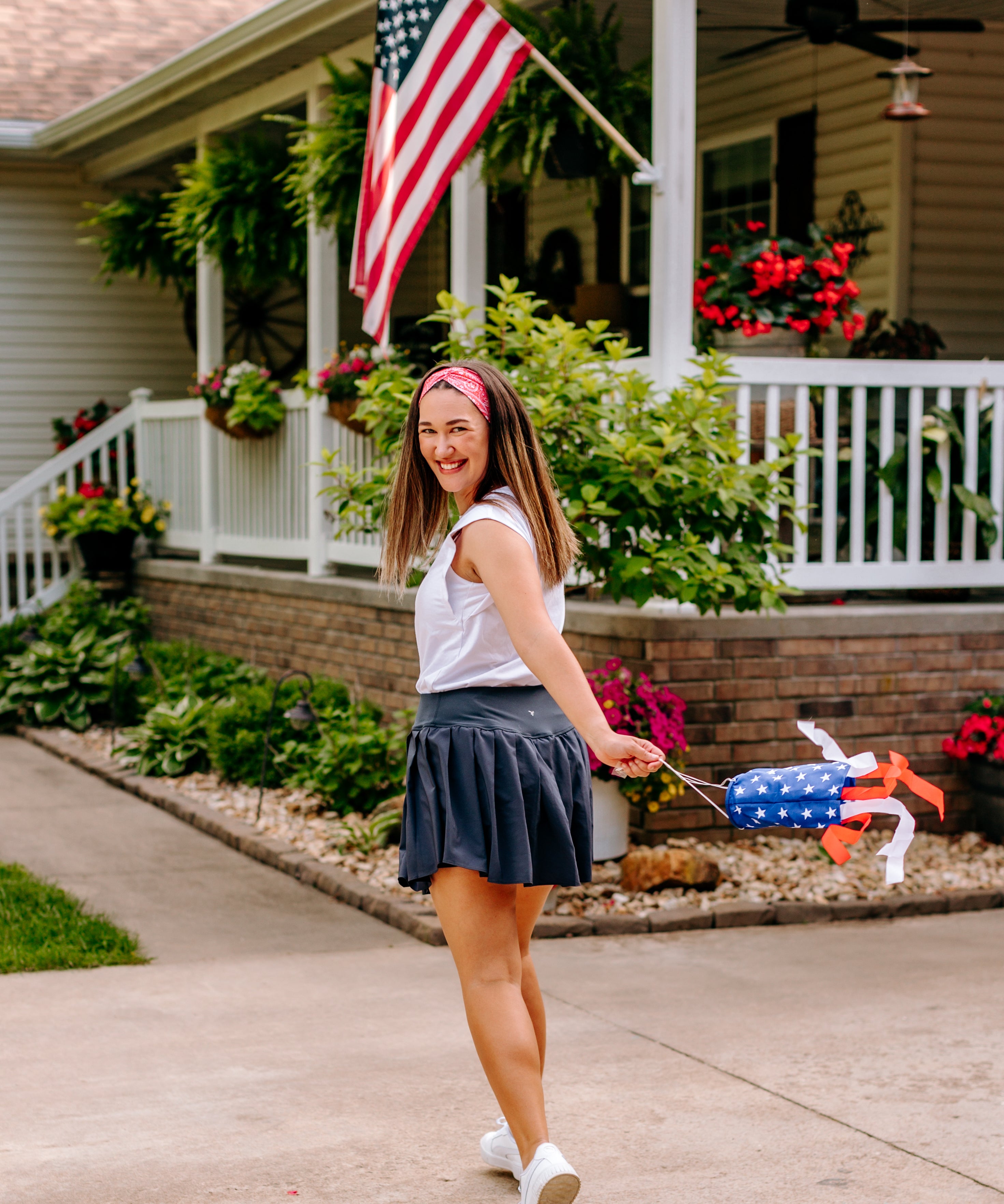 Woman with long straight hair type happily wearing the most comfortable hand-made headband in the print Summer Nights on Cherry.