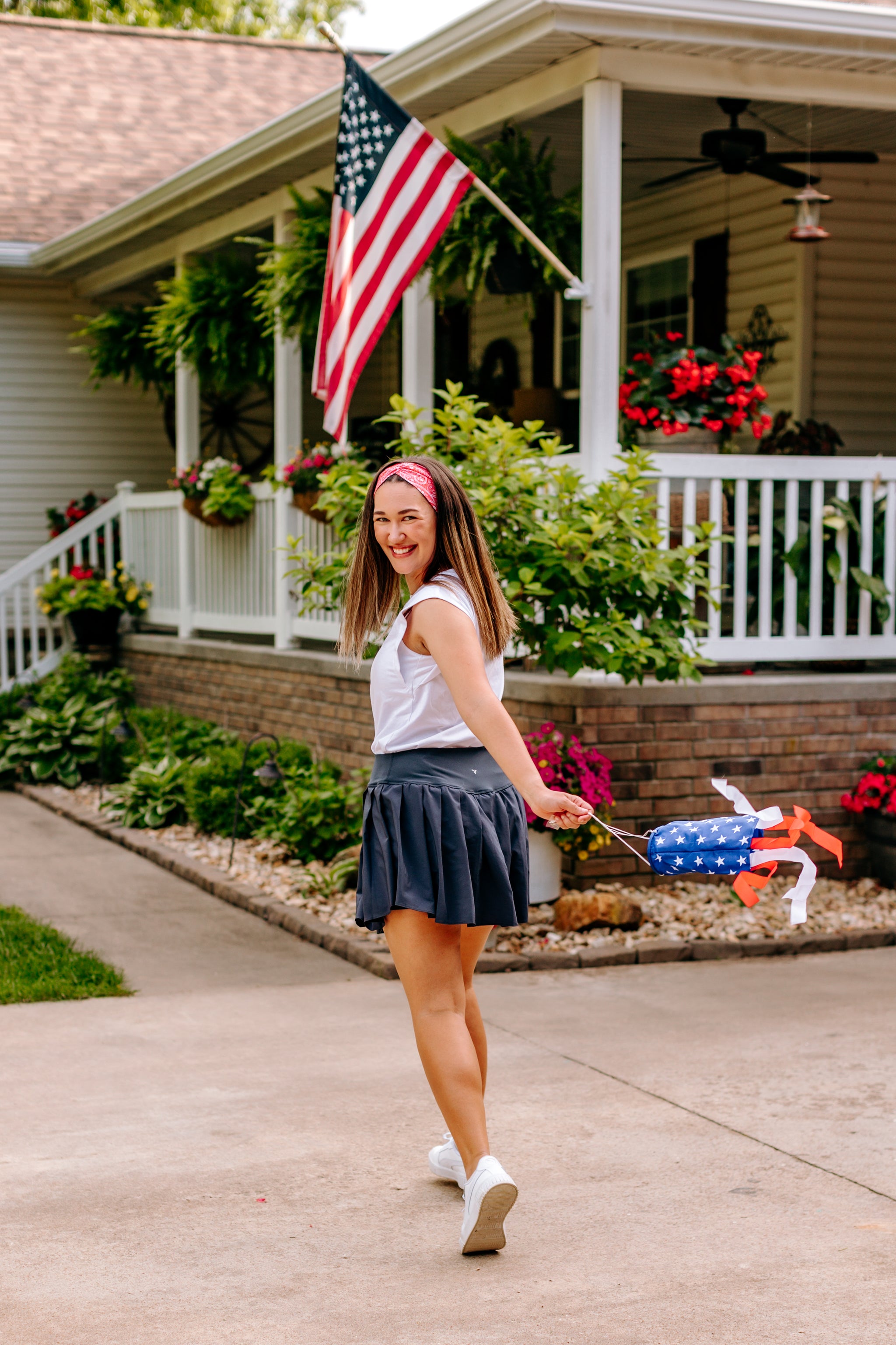 Woman with long straight hair type happily wearing the most comfortable hand-made headband in the print Summer Nights on Cherry.