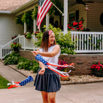 Woman with long straight hair type happily wearing the most comfortable hand-made headband in the print Summer Nights on Cherry.
