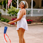 Woman with curly hair type happily wearing the most comfortable hand-made headband in the print Summer Nights on Baby Blue.