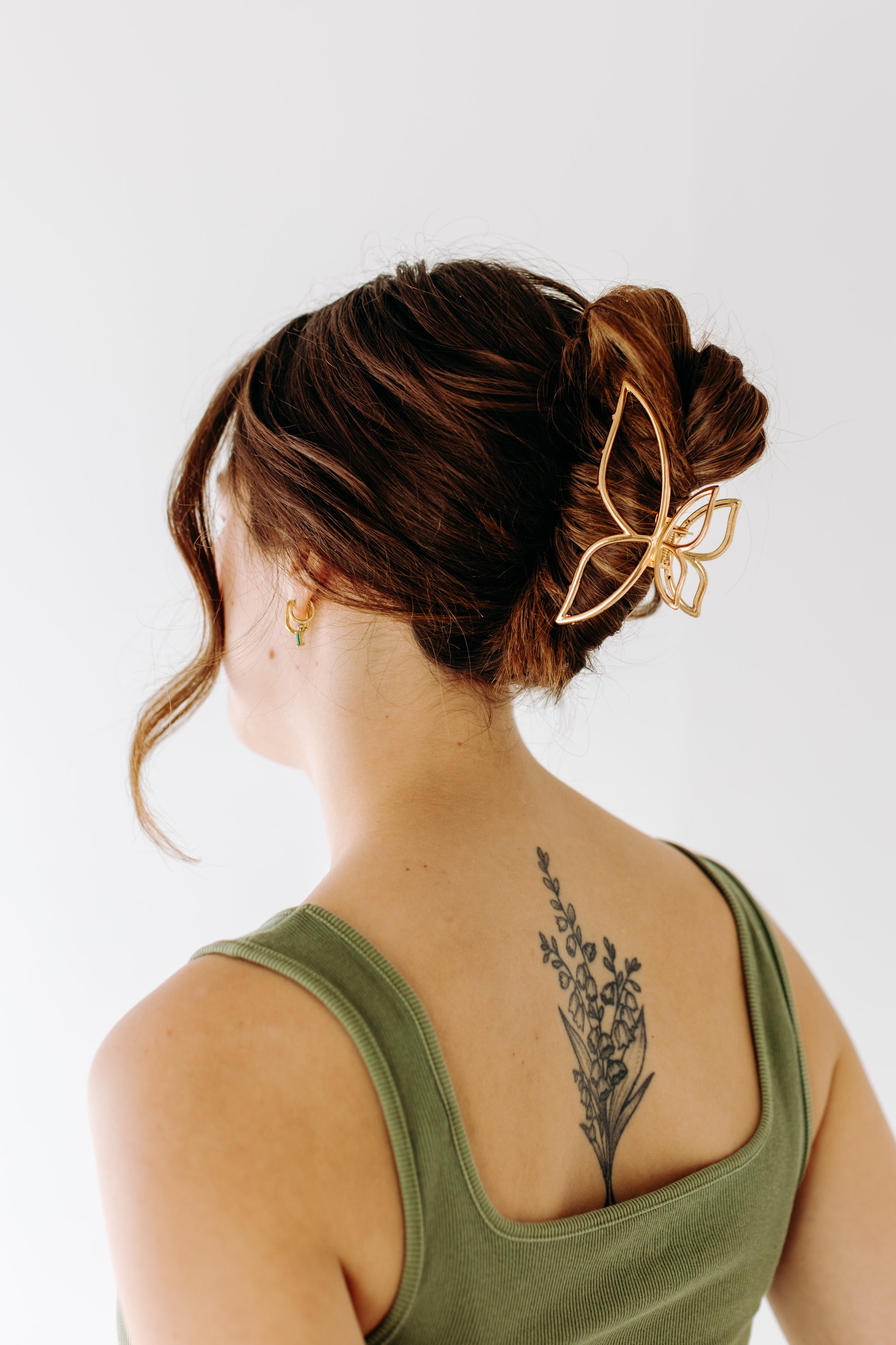 A woman with long hair styled perfectly with the Butterfly Kisses Lilac Clip, showing both fashion and functionality.