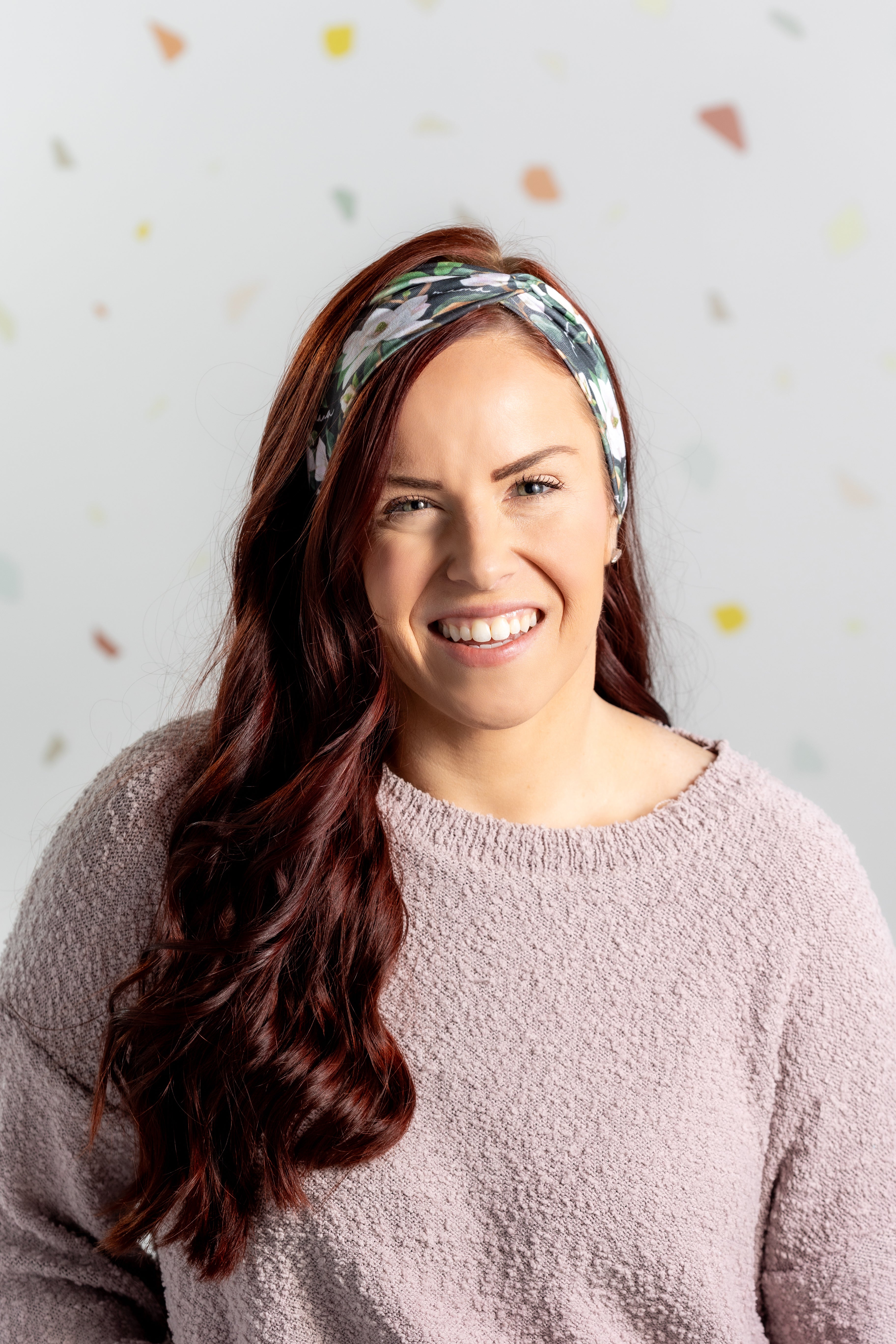 A black headband with white floral pattern and "Mama" script, offering confidence and functionality. Features one size fits most, machine washable, ultra stretchy poly-knit blend, versatile 3-in-1 twist style, sweat absorbent double-layer fabric.