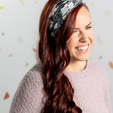 A black headband with white floral pattern and "Mama" script, offering confidence and functionality. Features one size fits most, machine washable, ultra stretchy poly-knit blend, versatile 3-in-1 twist style, sweat absorbent double-layer fabric.