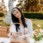 Woman with long hair happily wearing the most comfortable hand-made headband in the print Wren Floral.