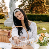 Woman with long hair happily wearing the most comfortable hand-made headband in the print Wren Floral.