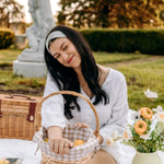 Woman with long hair happily wearing the most comfortable hand-made headband in the print Wren Floral.