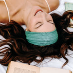 Woman with long hair happily wearing the most comfortable hand-made headband in the print Dottie on Emerald.