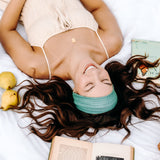 Woman with long hair happily wearing the most comfortable hand-made headband in the print Dottie on Emerald.