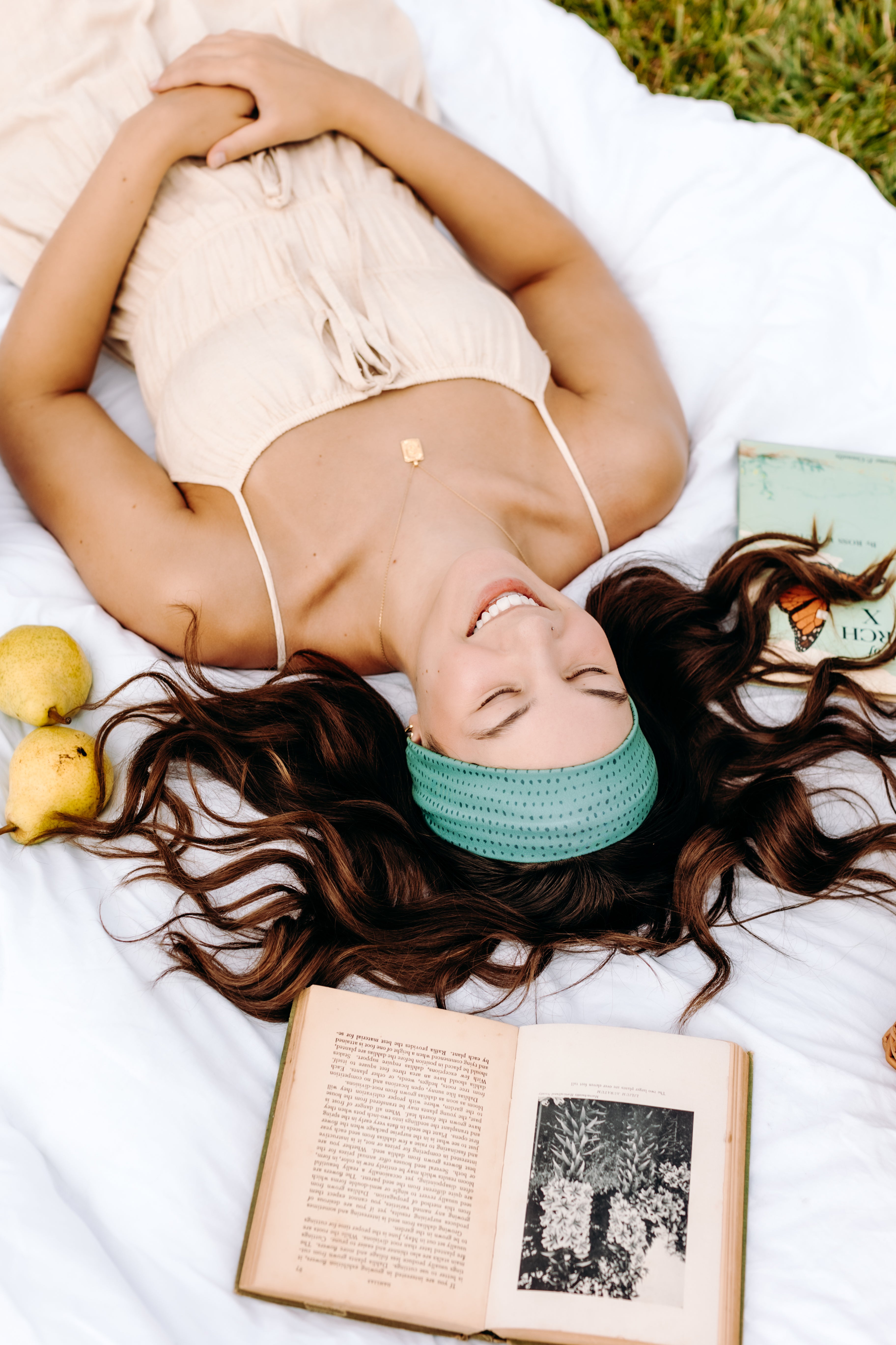 Woman with long hair happily wearing the most comfortable hand-made headband in the print Dottie on Emerald.