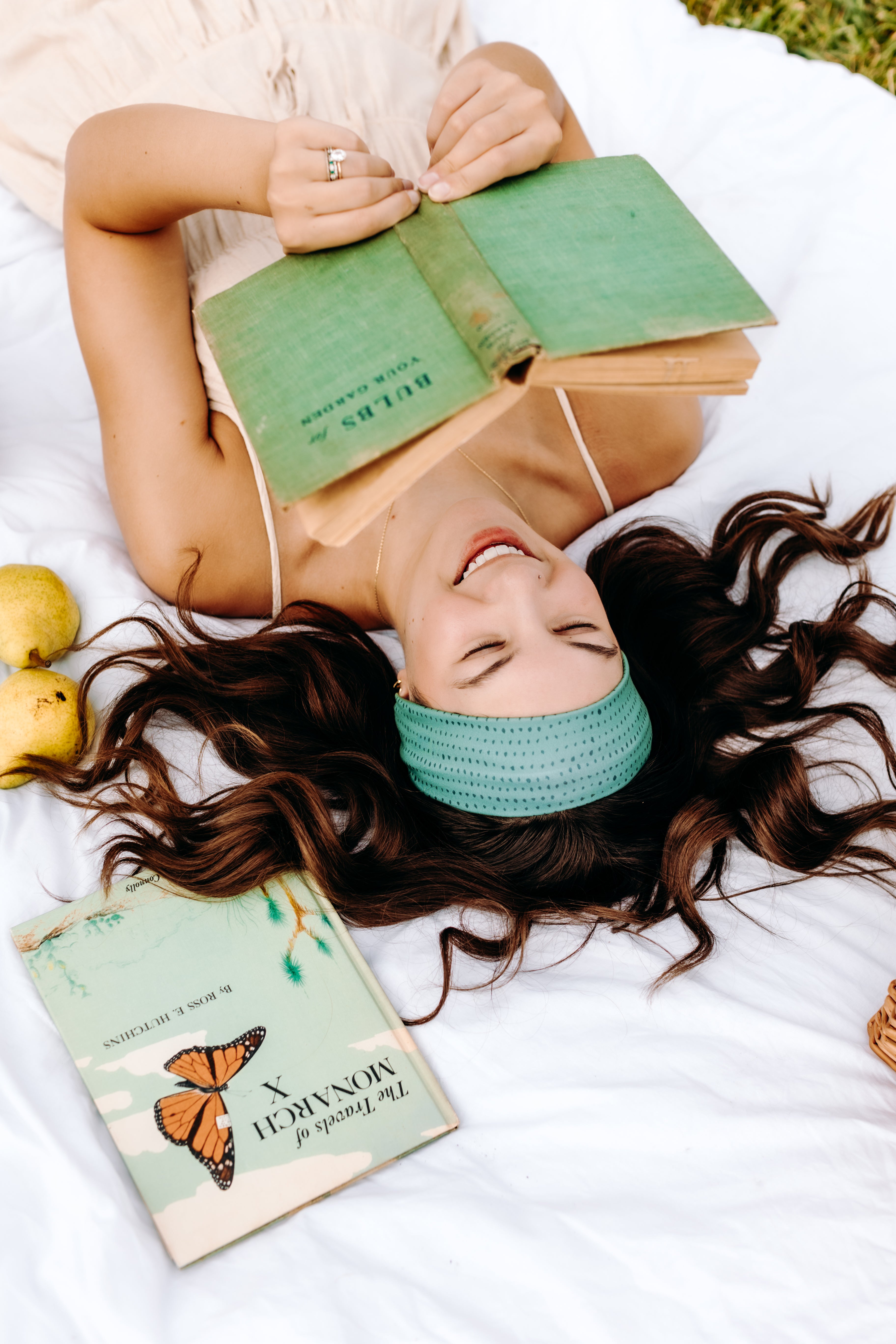 Woman with long hair happily wearing the most comfortable hand-made headband in the print Dottie on Emerald.