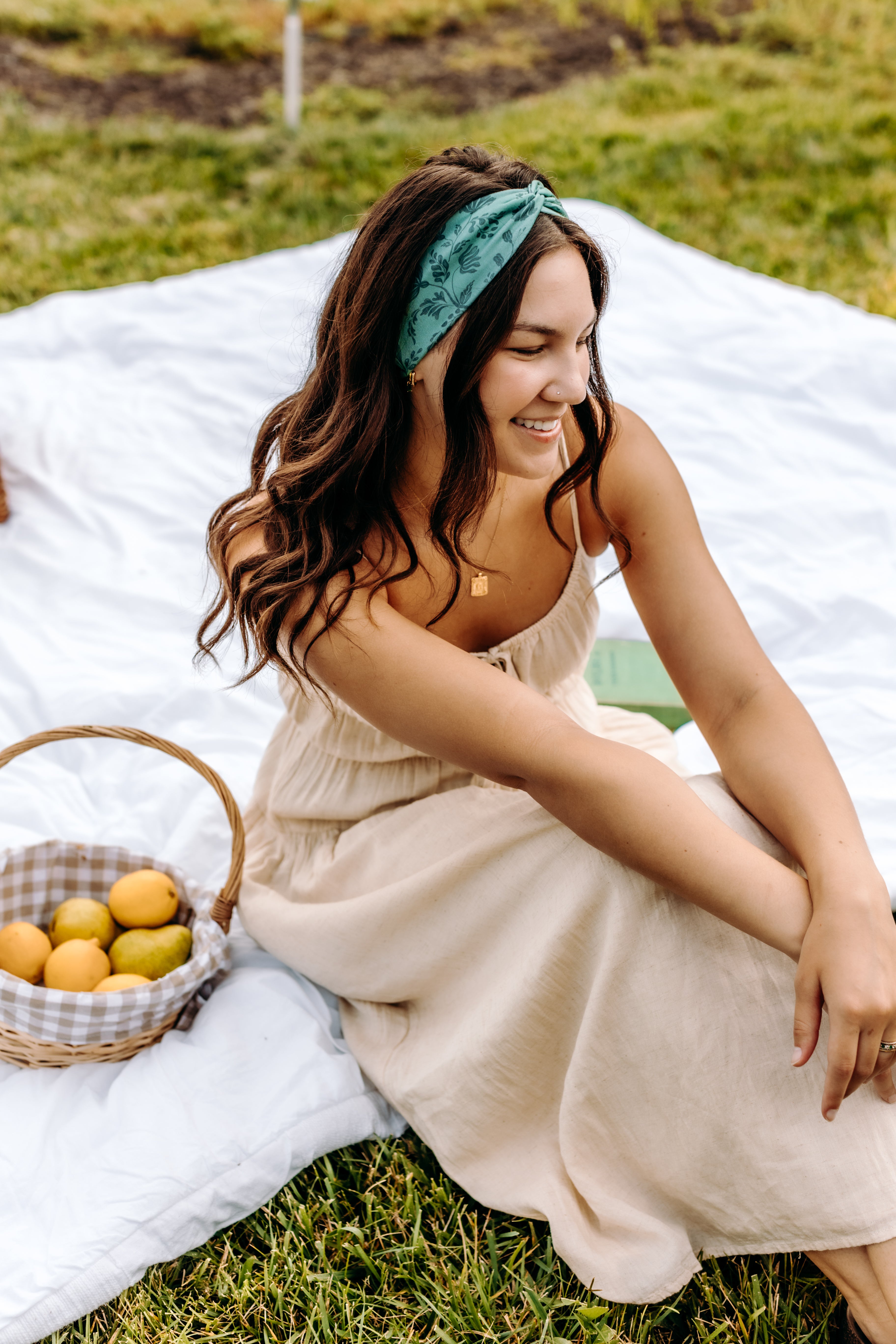 Woman with long hair happily wearing the most comfortable hand-made headband in the print Opal Floral.